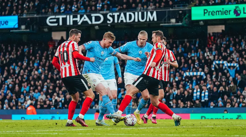 Manchester City and Sunderland players competing for the ball during a Premier League match at the Etihad Stadium.
