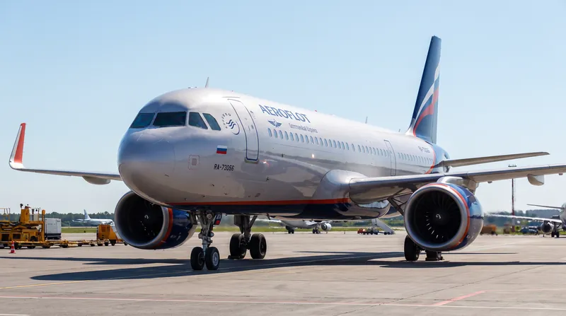 A modern Aeroflot commercial passenger jet parked on an airport tarmac under a clear sky.