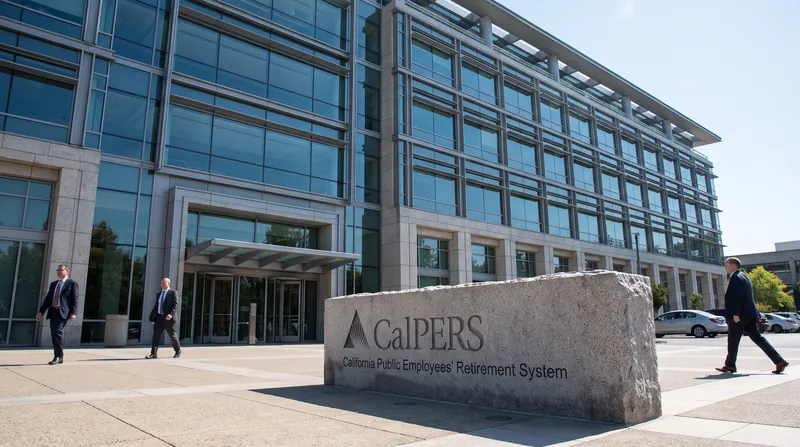 The exterior of the CalPERS headquarters building in Sacramento, California, featuring a stone sign.