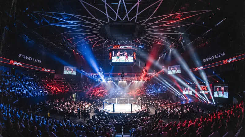 The glowing octagon of the Ultimate Fighting Championship set up inside a packed Etihad Arena in Abu Dhabi.