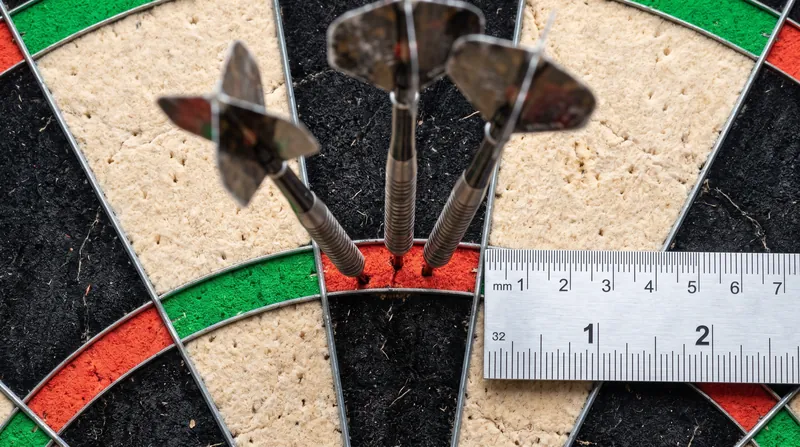 Hitting an 8-millimeter target from nearly eight feet away requires absolute consistency in board placement.