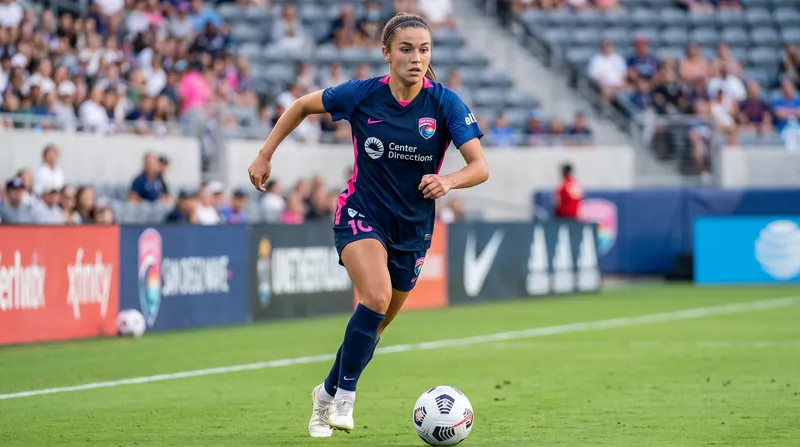 18-year-old Melanie Barcenas dribbling a soccer ball in a San Diego Wave FC uniform during a match.