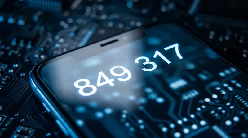 A close-up view of a smartphone screen showing a six-digit authentication code in bright text.