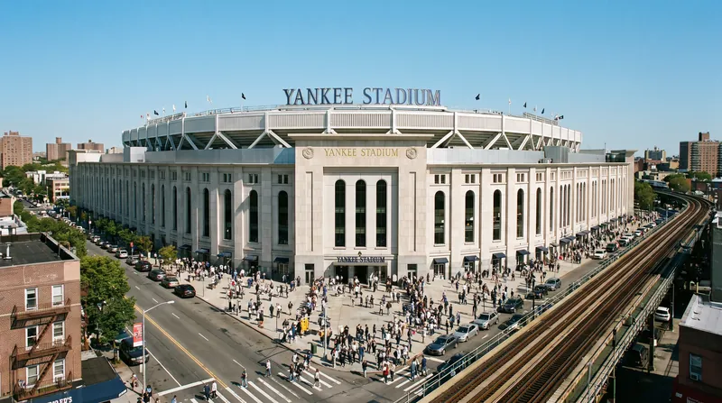 A wide exterior view of Yankee Stadium in New York City during the daytime.