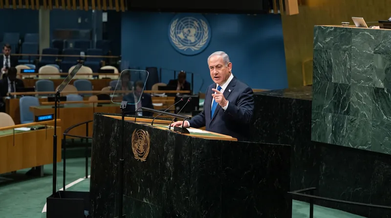 Israeli Prime Minister Benjamin Netanyahu addresses a largely empty General Assembly hall after dozens of envoys walked out.