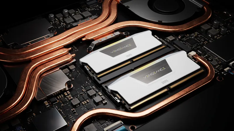 Close-up view of a gaming laptop motherboard featuring DDR5 memory slots and copper heat pipes.
