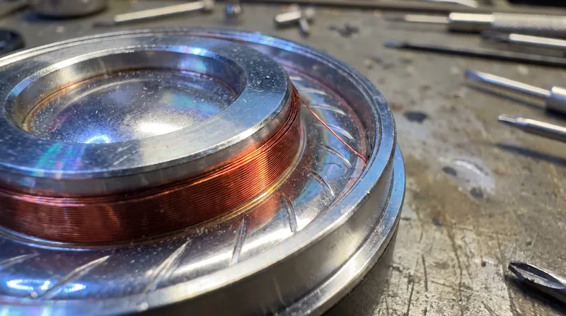 High-impedance headphones use thinner voice coil wire, which reduces moving mass but increases electrical resistance.