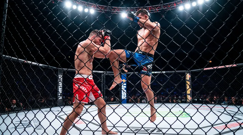 Two mixed martial artists exchanging strikes inside the UFC Apex cage during a Contender Series bout.