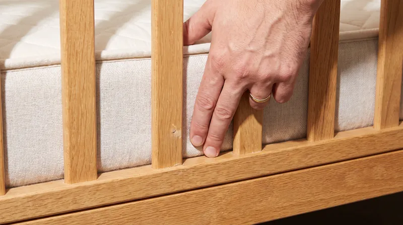 A safe crib requires a firm mattress that sits completely flush against the interior walls.