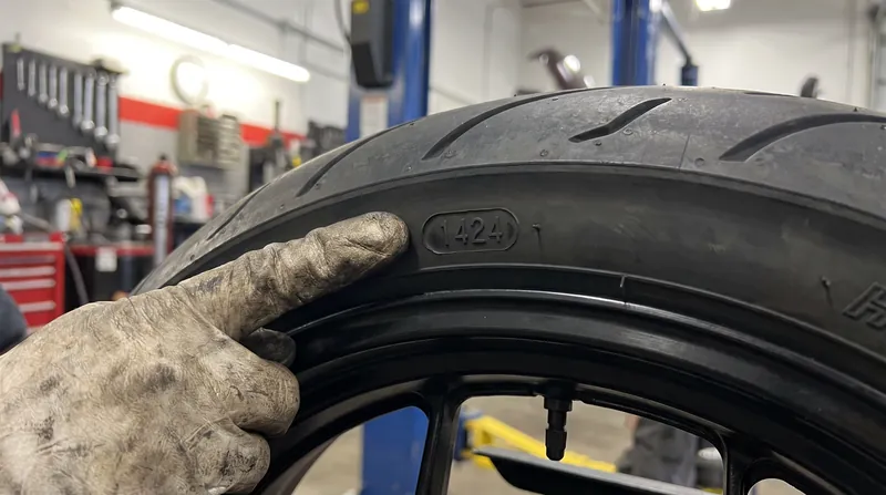 The DOT date code reveals the exact week and year the tire was manufactured, dictating its safe lifespan.