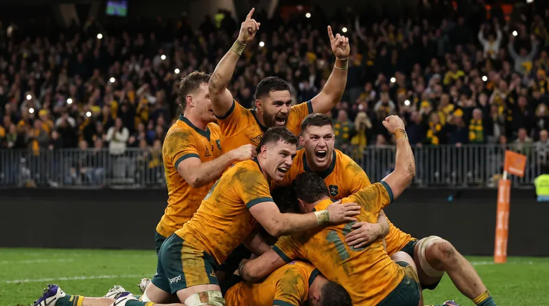 Australian Wallabies rugby players celebrating their victory over South Africa on the pitch at Optus Stadium.