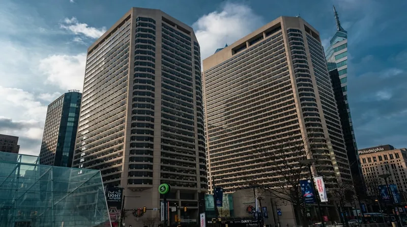 The Centre Square office towers in downtown Philadelphia, featuring a large stainless steel clothespin sculpture in the plaza.