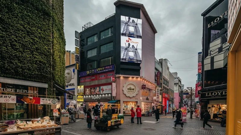 Seoul's Pedestrian Priority Street projects utilize patterned asphalt to signal a shared environment and disrupt driver assumptions of priority.