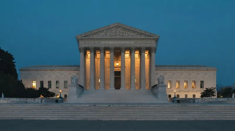 A low-angle view of a grand supreme court building facade featuring classical stone columns.