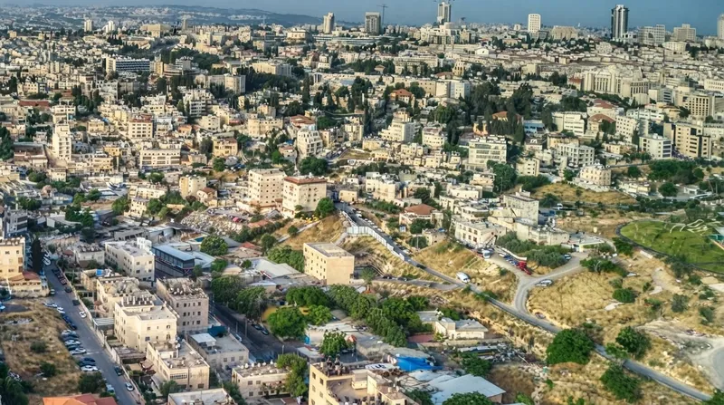 Exterior view of the British Consulate General building in East Jerusalem with stone walls and security barriers.
