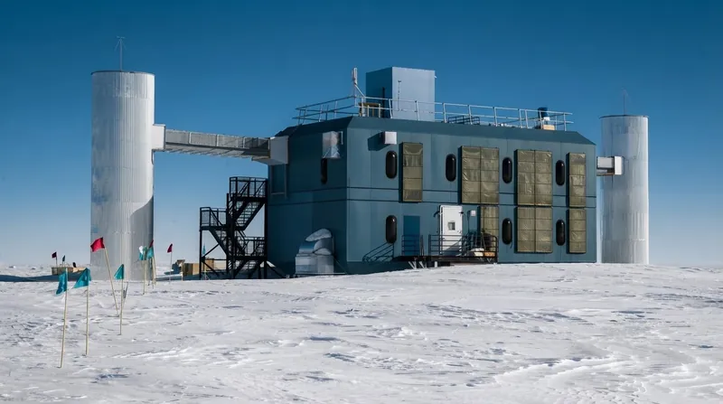 The IceCube Neutrino Observatory surface laboratory building stands on the snowy expanse of the South Pole.