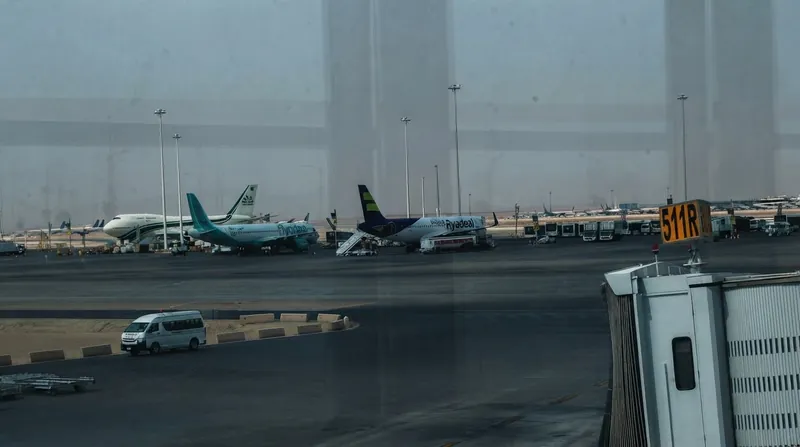 Thick black smoke billows from the terminal complex at King Khalid International Airport in Riyadh.