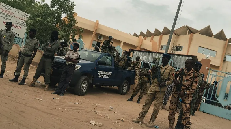 French and Chadian military officials shake hands during a formal signing ceremony in N'Djamena.