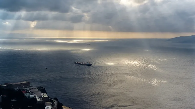 Aerial view of the narrow Strait of Gibraltar separating the rocky coasts of Spain and Morocco.