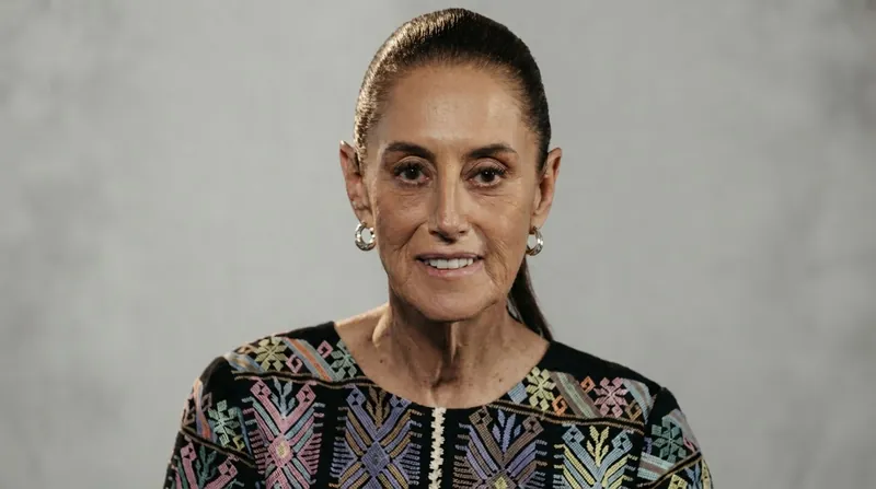 Mexican President Claudia Sheinbaum speaking at a podium during an official press conference.