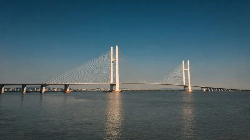 Commercial trucks adorned with Chinese and North Korean flags drive across the New Yalu River Bridge.