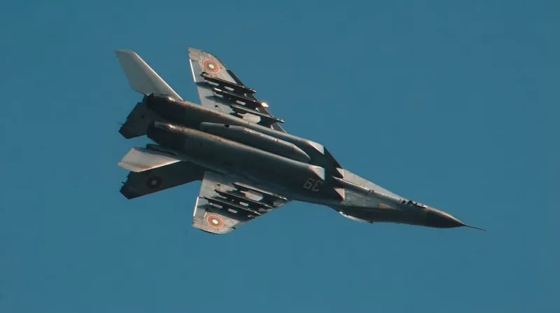 A Bulgarian Air Force MiG-29 fighter jet parked on a tarmac at dusk with ground crew nearby.