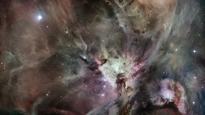 The Orion spacecraft flying over the heavily cratered surface of the lunar far side.