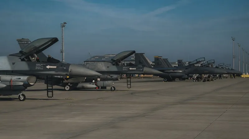 A Romanian Air Force F-16 fighter jet parked on a military tarmac at dusk.