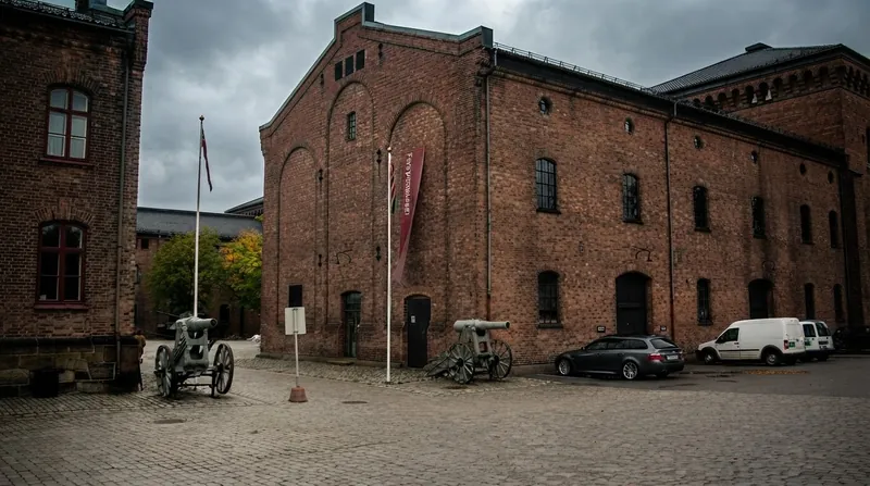 A modern electric vehicle parked near a military checkpoint with soldiers in the background.