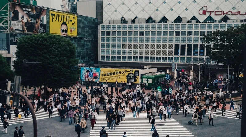 The exterior of the SoftBank Group corporate headquarters building in Tokyo illuminated at dusk.