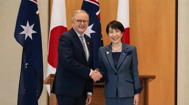 Japanese Prime Minister Sanae Takaichi speaking at a podium in the Japanese parliament.