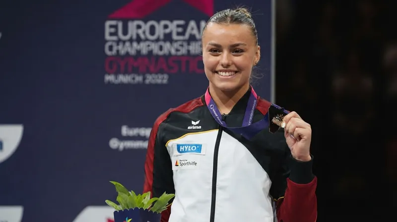 German gymnast Emma Malewski balancing on the beam during the 2026 World Gymnastics Championships in Rotterdam.