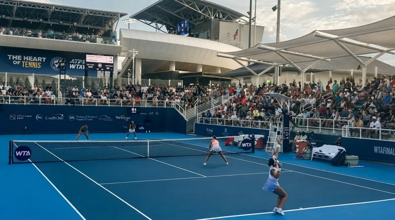 American tennis player Iva Jovic hits a two-handed backhand on a blue hard court.