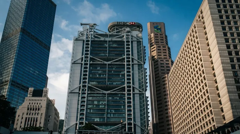 Exterior view of an HSBC bank branch building in the Hong Kong financial district during daytime.