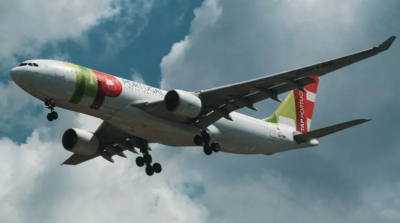 A TAP Air Portugal aircraft parked on an airport tarmac alongside a Lufthansa jet.