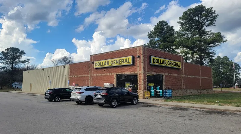 Exterior view of a Dollar General retail store with customers walking near the entrance.