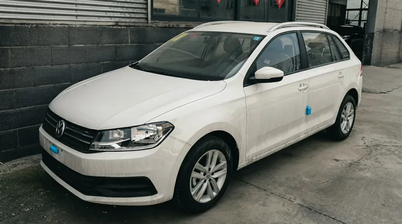 A white Volkswagen autonomous test vehicle with roof-mounted sensors driving on a city street in Hefei, China.